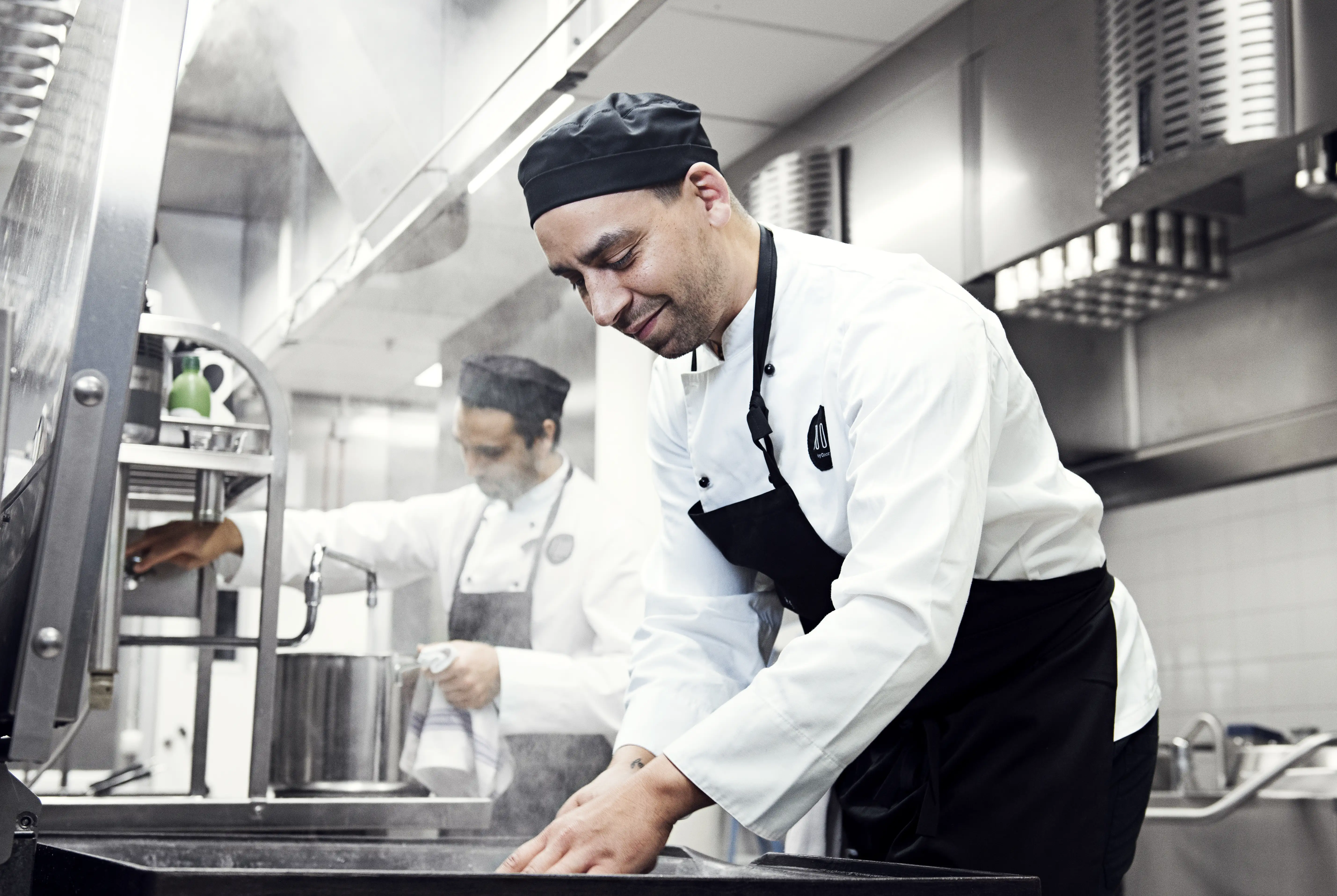 Chefs preparing food in a restaurant kitchen